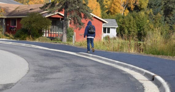 A local community member walks up Ben Walters Lane on a newly completed sidewalk on Monday, Sept. 30, 2024, in Homer, Alaska. (Delcenia Cosman/Homer News)