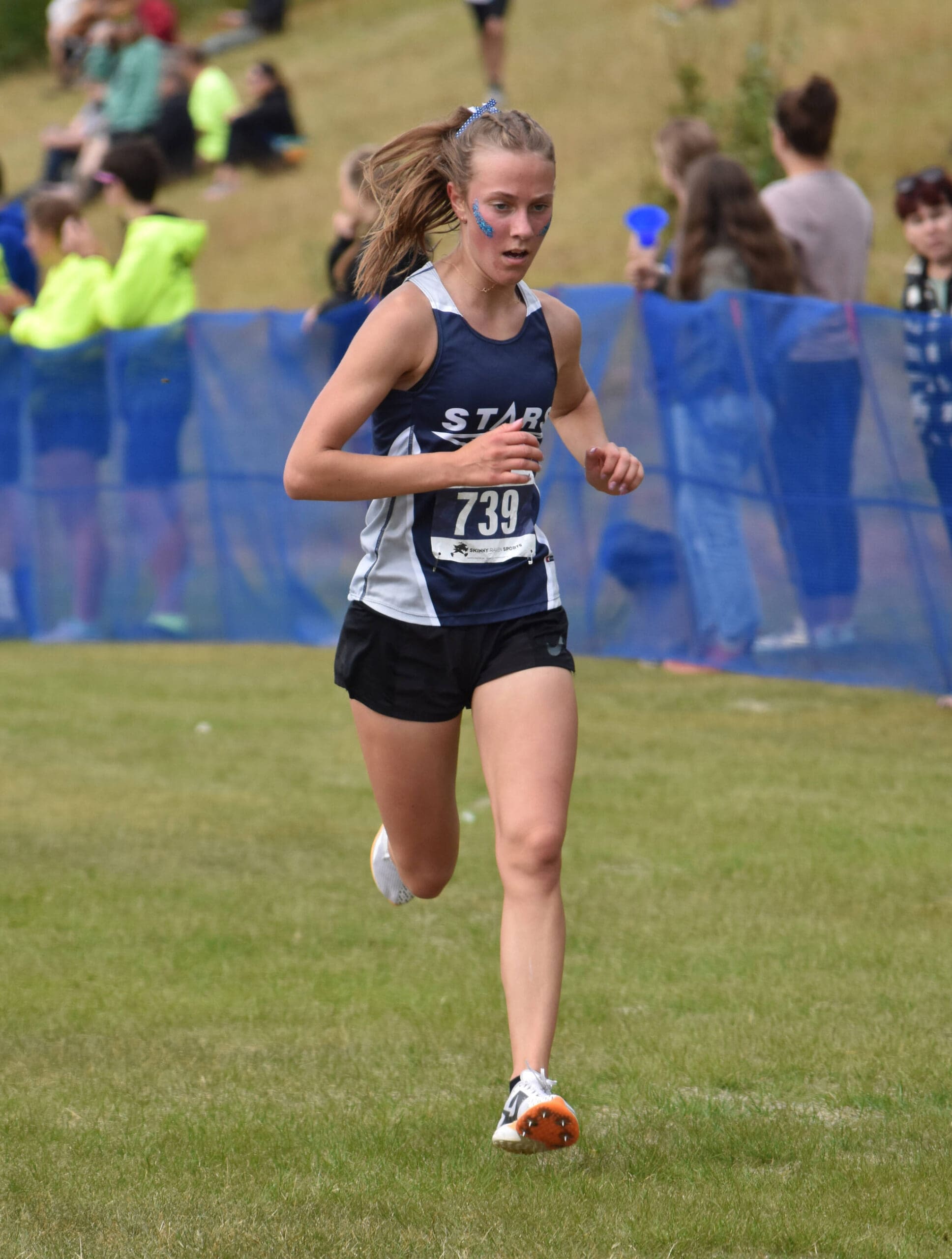 Soldotna’s Tania Boonstra nears the finish of the girls varsity race at the Ted McKenney XC Invitational on Saturday, Aug. 23, 2025, at Tsalteshi Trails just outside of Soldotna, Alaska. (Photo by Jeff Helminiak/Peninsula Clarion)