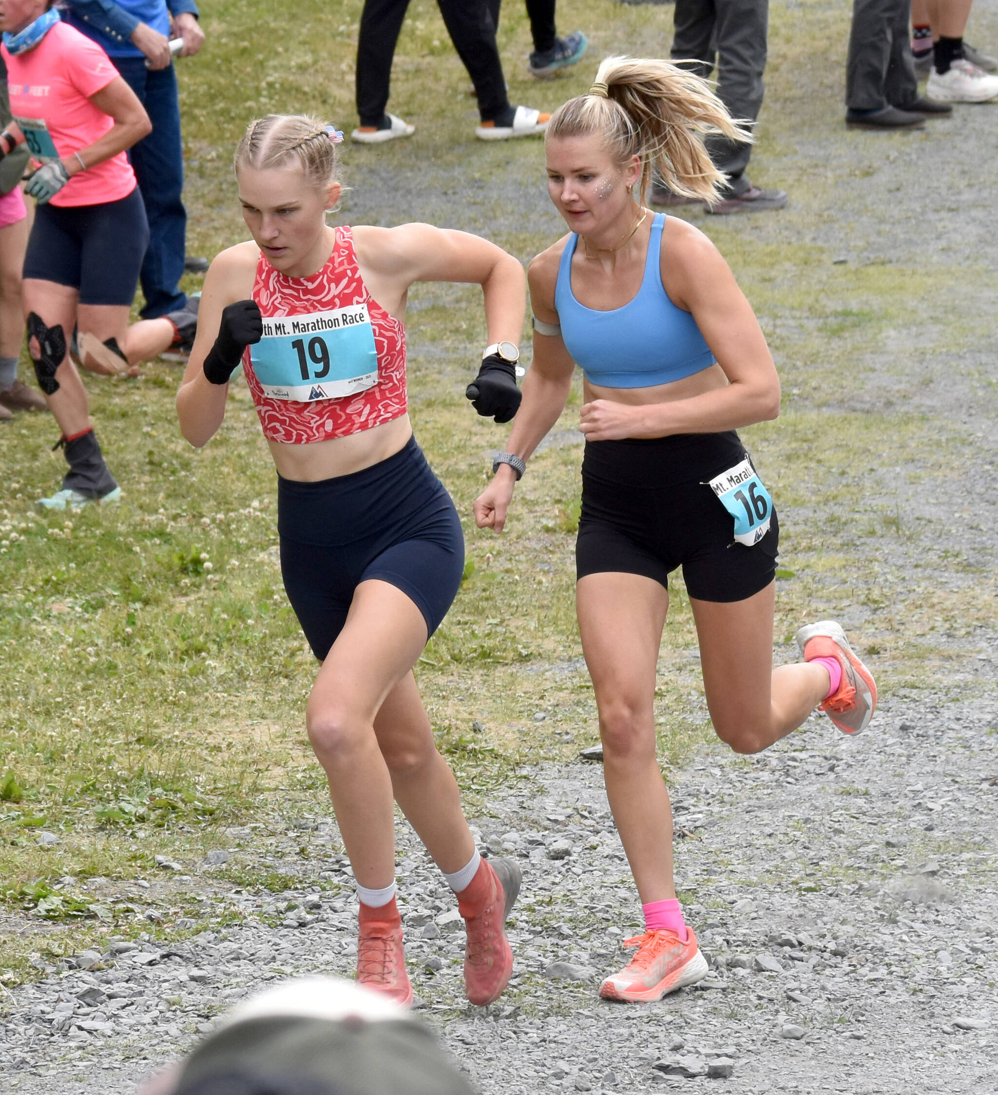 Nevada’s Claire Nelson, 22, and Anchorage’s Taylor Deal, 31, approach the mountain during the women’s race at the Mount Marathon Race on July 4, 2025, in Seward, Alaska. (Photo by Jeff Helminiak/Peninsula Clarion)