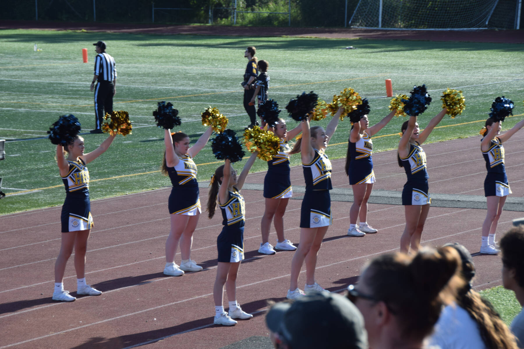 Homer Mariner cheerleaders rouse the gathered crowd at the first home game of the season on Friday. (Chloe Pleznac/Homer News)