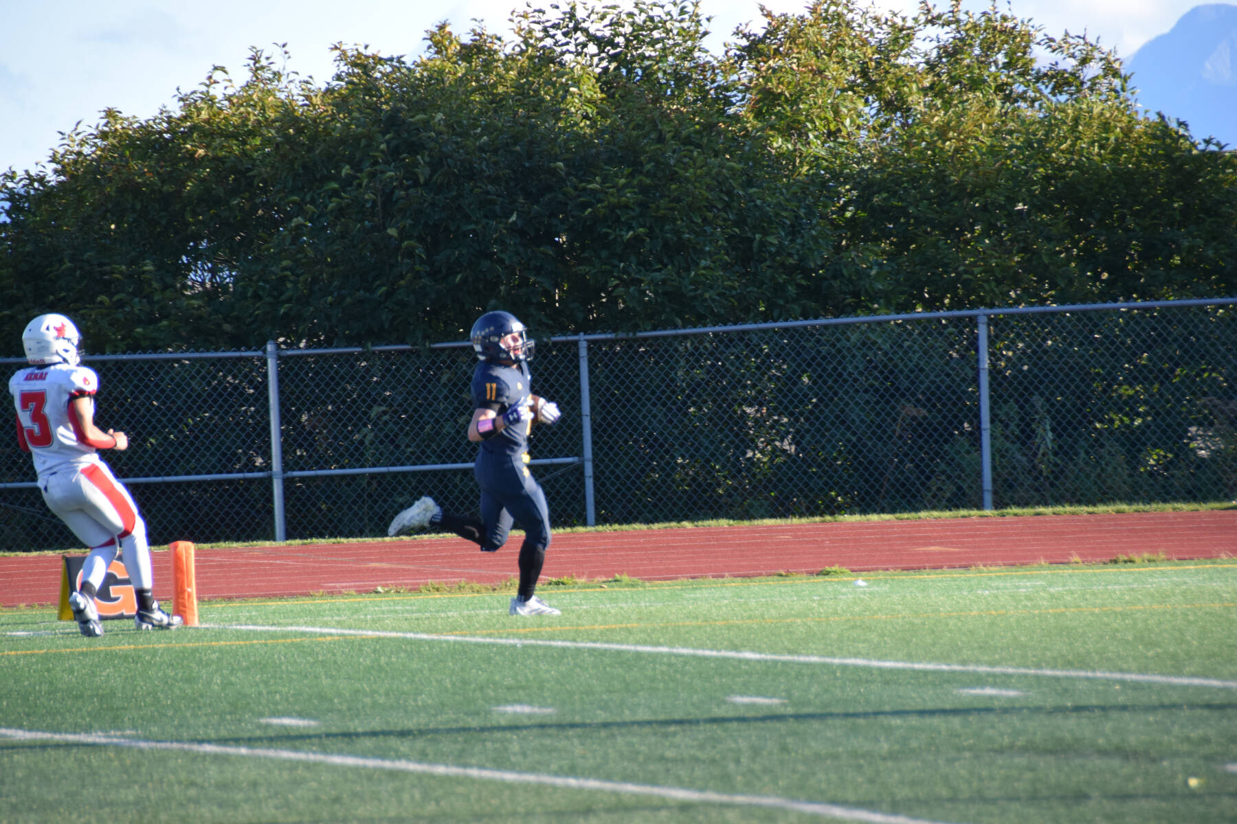 Justus Grimes (11) scores a touchdown in the second quarter of the varsity game between the Homer Mariners and the Kenai Kardinals on Friday, Aug. 29, 2025, at the Homer High School football field in Homer, Alaska. (Delcenia Cosman/Homer News)