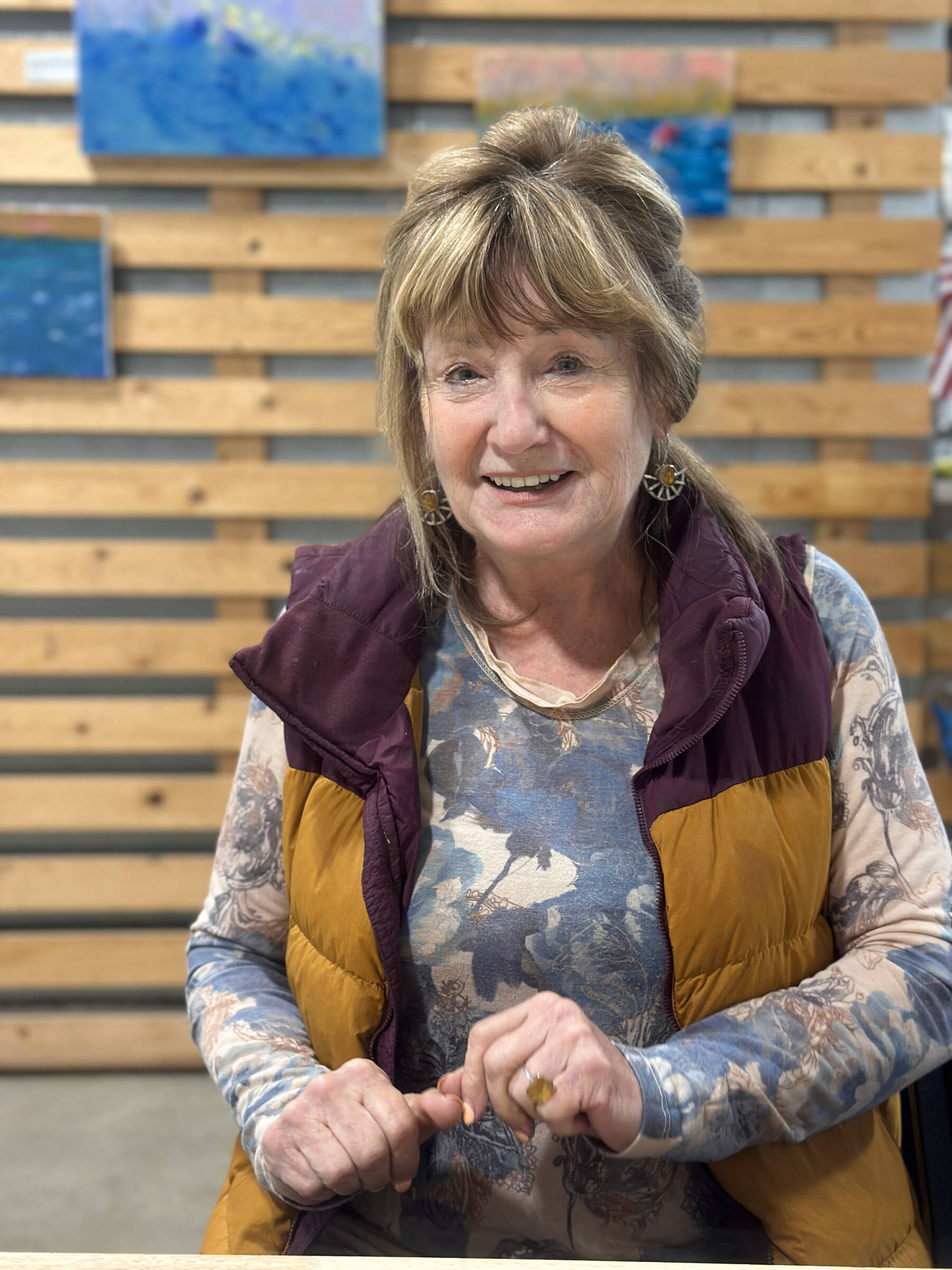 Artist Rosemary “Rozzi” Redmond shows a series of acrylic paintings with fishing themes at Grace Ridge Brewing in Homer, Alaska. The exhibit is open through September 2025. Photo by Christina Whiting