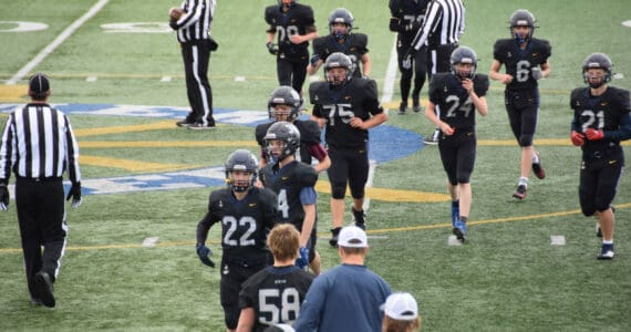 Homer Mariner football players exit the field on Saturday, Sept. 13, ahead of the 2025 home game against Houston. (Chloe Pleznac/Homer News)