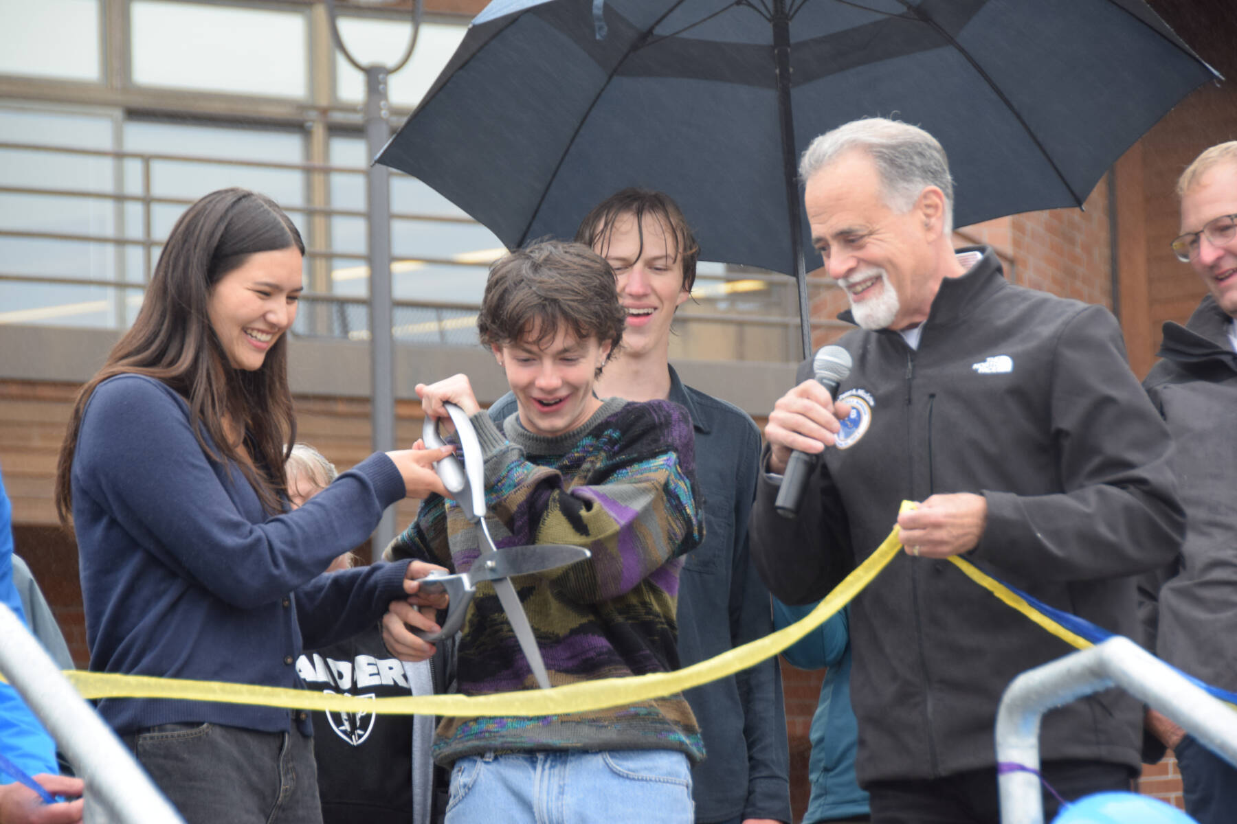 Homer High School Student Body President Marina Co and Vice President Reid Rauch cut the ribbon on Thursday, Sept. 11, 2025 while Kenai Peninsula Borough Mayor Peter Micciche and Homer High School Principal Eric Pederson look on. (Chloe Pleznac/Homer News)