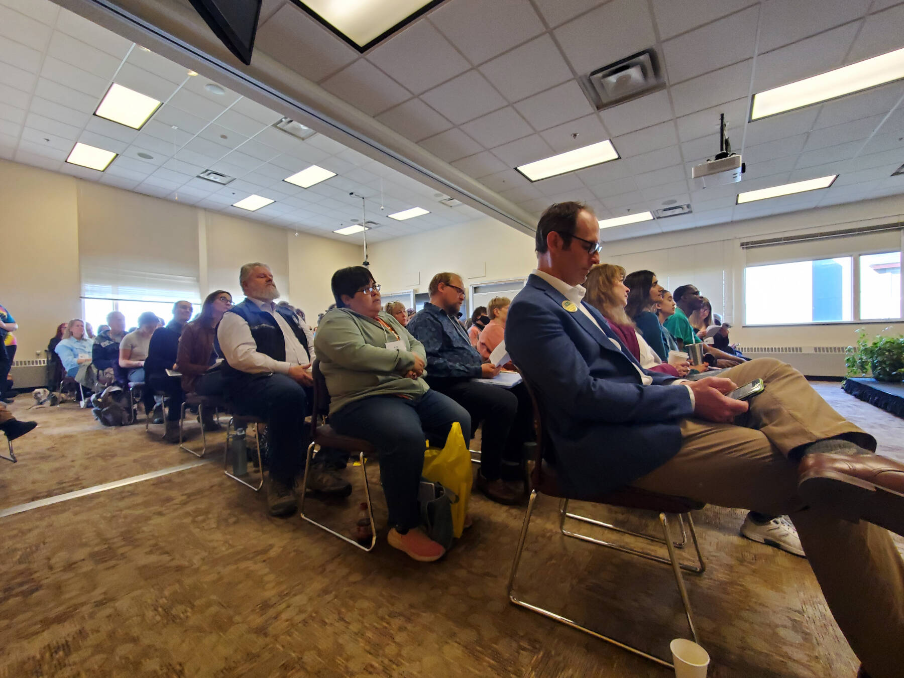 Kachemak Bay Writers Conference attendees fill the room in Kachemak Bay Campuss Pioneer Hall during the opening panel on Saturday, May 18, 2024 in Homer, Alaska. (Delcenia Cosman/Homer News)