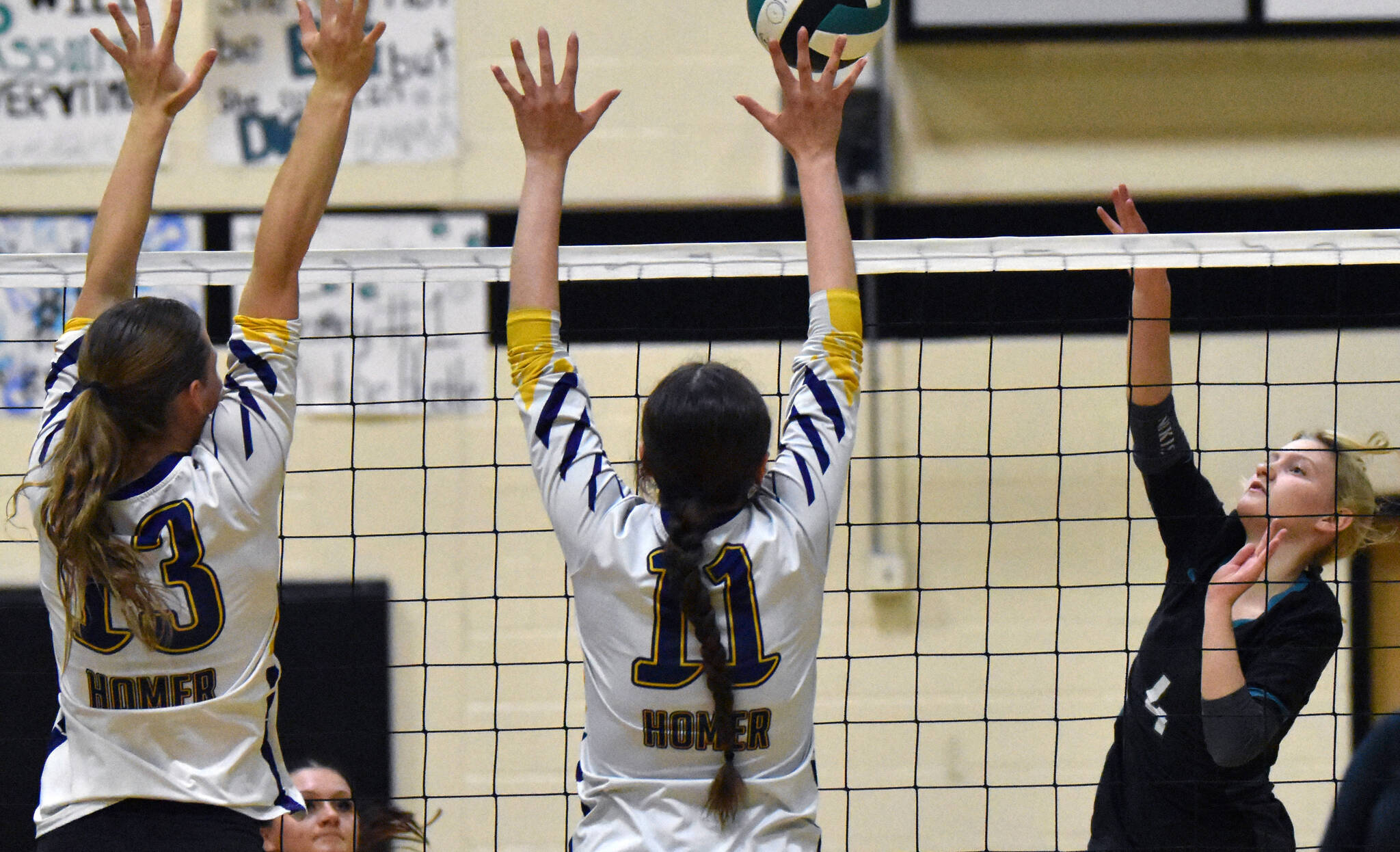 Nikiskis Hailey Hutchins attacks against Homers Madaln Miotke and Gracey Bradshaw on Tuesday, Sept. 23, 2025, at Nikiski Middle-High School in Nikiski, Alaska. (Photo by Jeff Helminiak/Peninsula Clarion)