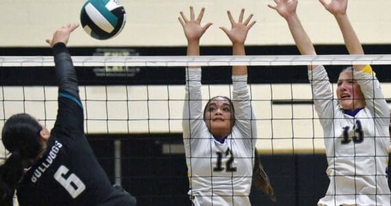 Nikiski's Halle Blades attacks against Homer's Alysha Nyvall and Madalyn Miotke on Tuesday, Sept. 23, 2025, at Nikiski Middle-High School in Nikiski, Alaska. (Photo by Jeff Helminiak/Peninsula Clarion)