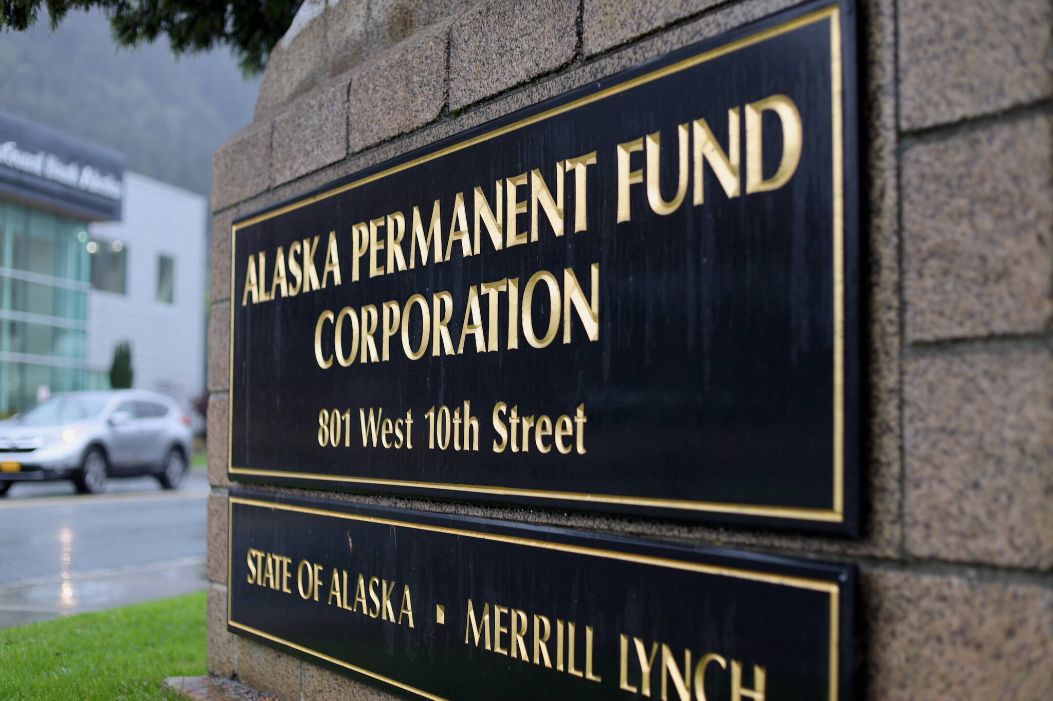 Cars drive past the Alaska Permanent Fund Corp. building in Juneau. (Clarise Larson / Juneau Empire)