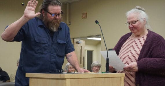 Homer City Council member Bradley Parsons (left) is sworn in by city clerk Renee Krause (right) on Monday, Oct. 13, 2025, in the Homer City Hall Cowles Council Chambers in Homer, Alaska, following his reelection to the council for one more year. Photo courtesy of Julie Engebretsen