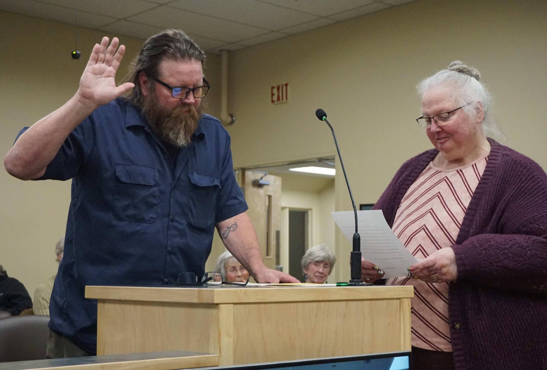 Homer City Council member Bradley Parsons (left) is sworn in by city clerk Renee Krause (right) on Monday, Oct. 13, 2025, in the Homer City Hall Cowles Council Chambers in Homer, Alaska, following his reelection to the council for one more year. Photo courtesy of Julie Engebretsen