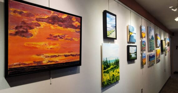 Artwork from a summer painting workshop is on display on the gallery wall in Kachemak Bay Campus's Pioneer Hall on Saturday, Oct. 18, 2025, in Homer, Alaska. (Delcenia Cosman/Homer News)