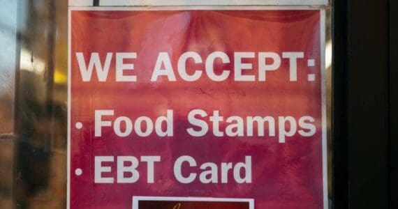 A sign for a store that accepts food stamps and exchange benefits transfer cards is seen in this 2019 photo. (Photo by Scott Heins/Getty Images via Alaska Beacon)