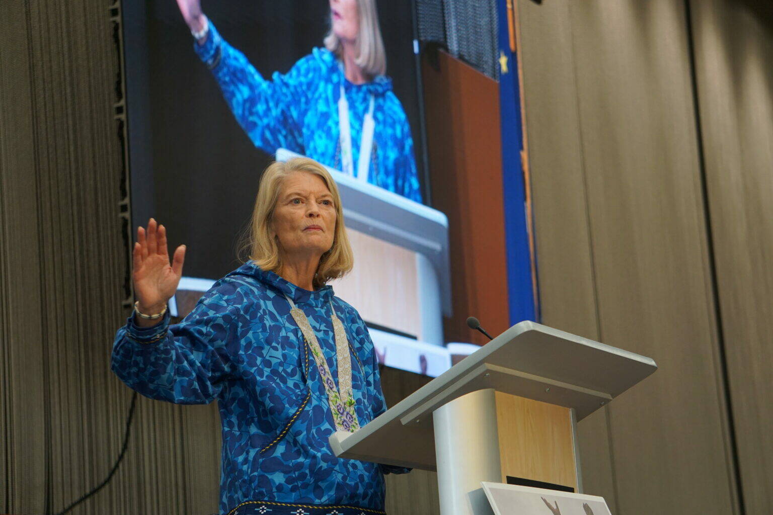 U.S. Sen. Lisa Murkowski, R-Alaska, speaks on Oct. 18, 2025, at the Alaska Federation of Natives convention in Anchorage. Behind her is a screen projeting her image as she speaks. (Photo by Yereth Rosen/Alaska Beacon)