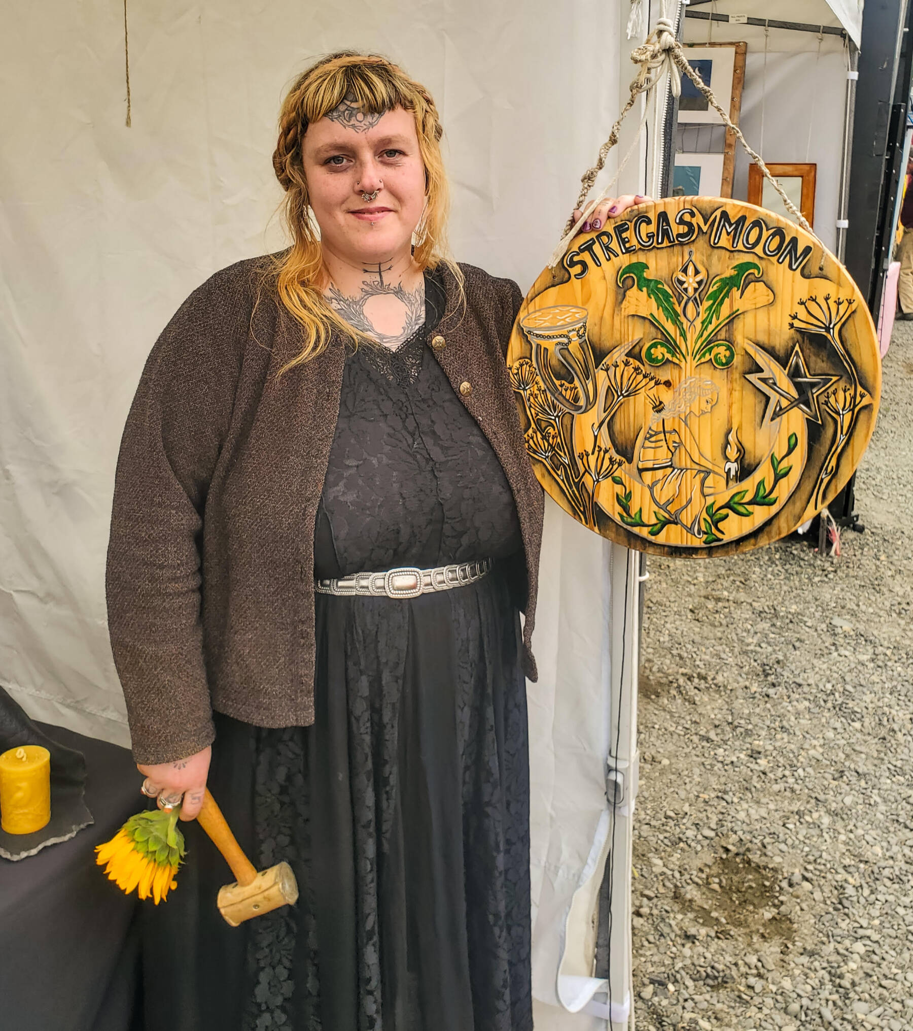 Carley Conemac, metal artist and owner of Stregas Moon Jewelry, is photographed at her seasonal booth at the Homer Farmers Market in the summer of 2025. Photo courtesy of Leah Moraes