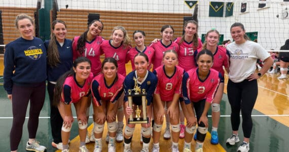 The Homer High School varsity volleyball team holds up their trophy after winning first place in the silver bracket at the Dimond/Service Tourney on Saturday, Oct. 25, 2025, in Anchorage, Alaska. Photo provided by Brenna Dornellas
