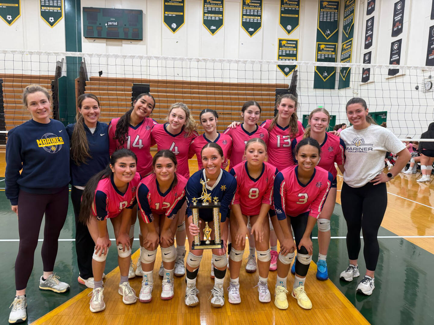 The Homer High School varsity volleyball team holds up their trophy after winning first place in the silver bracket at the Dimond/Service Tourney on Saturday, Oct. 25, 2025, in Anchorage, Alaska. Photo provided by Brenna Dornellas