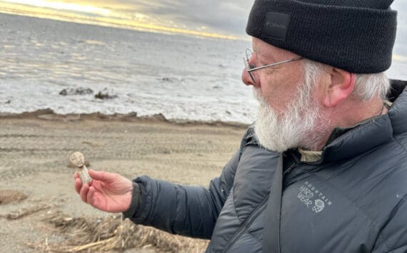 Archaeologist Rick Knecht holds a human figure that he found on the beach near the village of Quinhagak on Oct. 24, 2025. Photo courtesy Alice Bailey