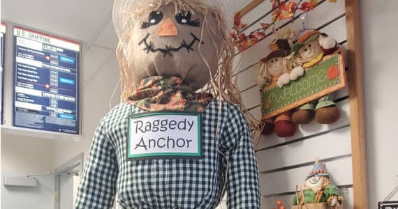 A friendly scarecrow stands on the counter at the Anchor Point Post Office in October 2025 in Anchor Point, Alaska. (Delcenia Cosman/Homer News)