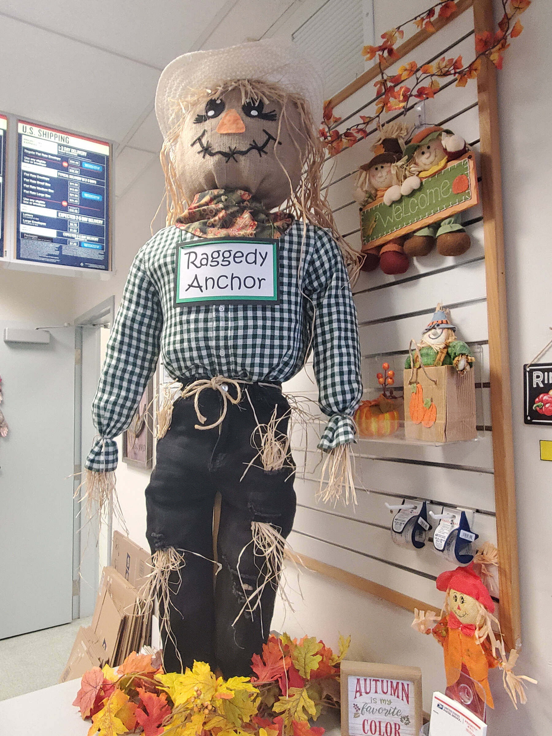 A friendly scarecrow stands on the counter at the Anchor Point Post Office throughout October 2025 in Anchor Point, Alaska. (Delcenia Cosman/Homer News)