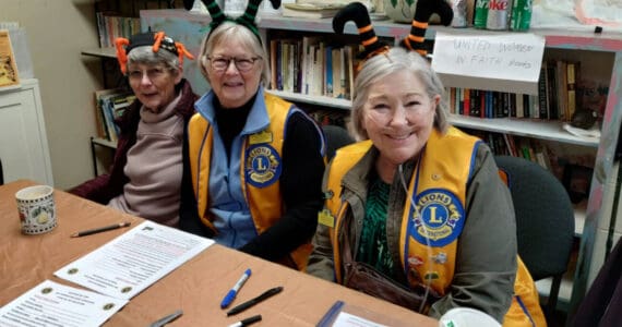 Lady Lions Marcia Lowe, Julie Small and Linda Petkash with the Homer Lions Club conduct sign-ups for Thanksgiving food boxes at the Homer United Methodist Church in Homer, Alaska. More than 230 families requested food boxes this year, an increase from 166 boxes in 2024. Photo provided by Deb Schmidt