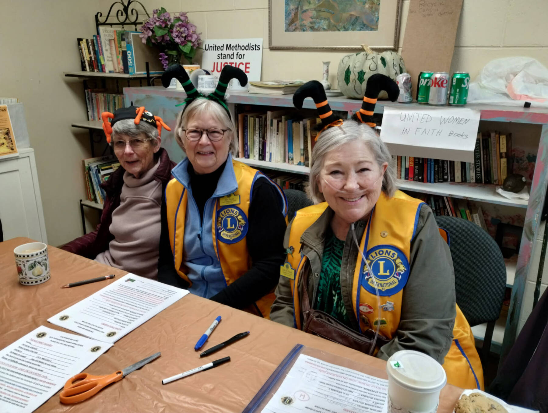 Lady Lions Marcia Lowe, Julie Small and Linda Petkash conduct sign-ups for Thanksgiving food boxes at the Homer United Methodist Church in Homer, Alaska. More than 230 families requested food boxes this year, an increase from 166 boxes dsitributed in 2024. Photo provided by Deb Schmidt