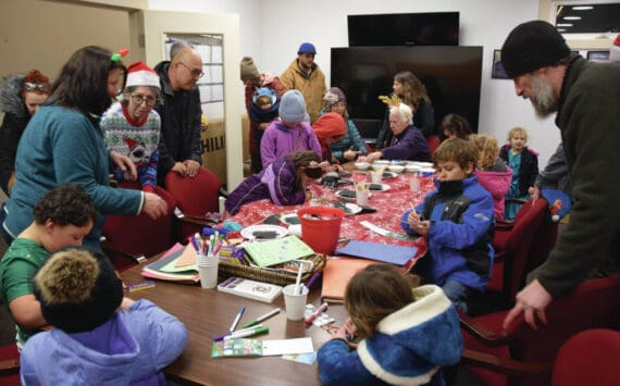 Kids and parents craft holiday ornaments during at the Homer Chamber of Commerce and Visitor Center during their annual Christmas tree lighting celebration on Thursday, Dec. 5, 2024, in Homer, Alaska. (Delcenia Cosman/Homer News)