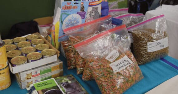 Bags of dog and cat food, toys and resources were made available by the local animal shelter, AK Mindful Paws, at the annual Community Resource Connect event at the SPARC building in Homer on January 28, 2025. (Chloe Pleznac/Homer News)