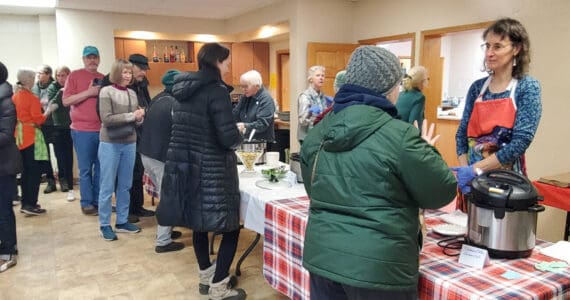 Community members line up for hot soup and bread during the Homer Community Food Pantry's annual Empty Bowl fundraiser on Friday, Nov. 7, 2025, at the Homer United Methodist Church in Homer, Alaska. (Delcenia Cosman/Homer News)