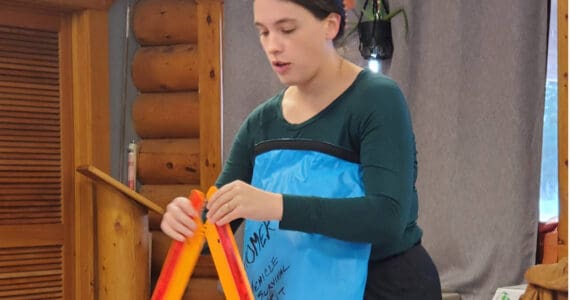 Homer public health nurse Emily Sears demonstrates tools in her vehicle emergency supply kit during a presentation on winter storm preparedness at the Anchor Point Senior Center on Thursday, Nov. 20, 2025, in Anchor Point, Alaska. (Delcenia Cosman/Homer News)