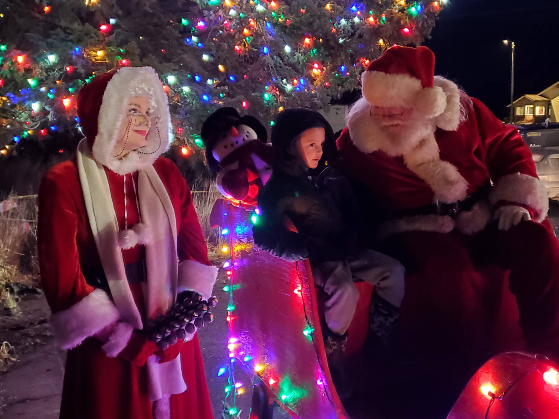 Santa and Mrs. Claus listen to children’s request for Christmas presents during the annual holiday tree lighting ceremony on Thursday, Dec. 4, 2025, at the Homer Chamber of Commerce in Homer, Alaska. (Delcenia Cosman/Homer News)