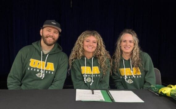 Photo courtesy of Sophie Tapley
Kenai Central’s Sophie Tapley (center) on Nov. 26<ins>,</ins><ins> 2025,</ins> commits to playing volleyball at the University of Alaska Anchorage during the 2026-2027 school year. Tapley was a varsity hitter for three years at Kenai Central.