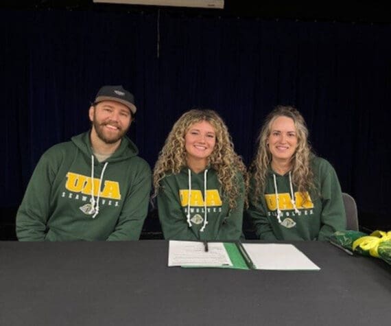 Photo courtesy of Sophie Tapley
Kenai Central’s Sophie Tapley (center) on Nov. 26<ins>,</ins><ins> 2025,</ins> commits to playing volleyball at the University of Alaska Anchorage during the 2026-2027 school year. Tapley was a varsity hitter for three years at Kenai Central.