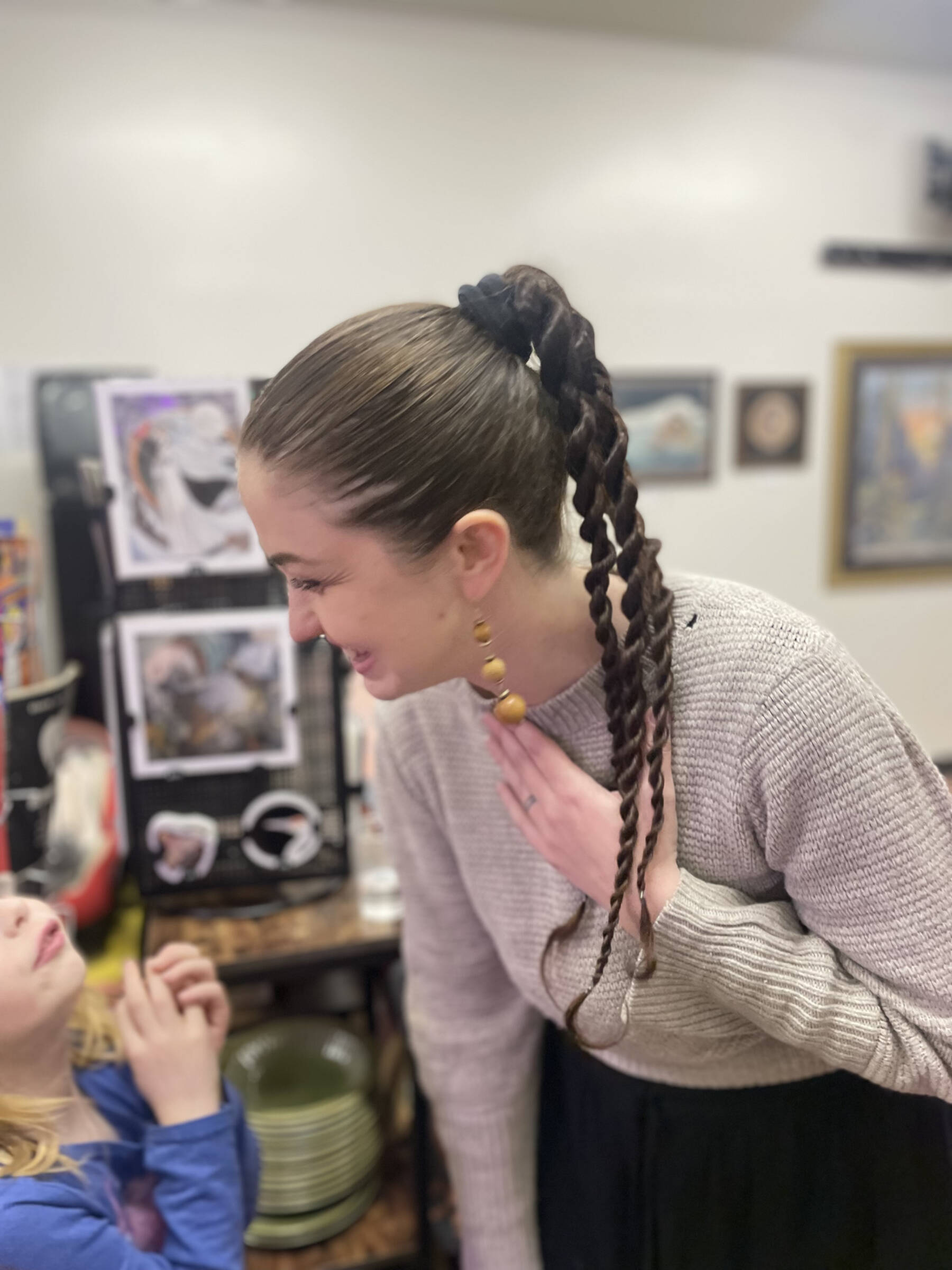 Artist Mira Featherstone is photographed at her Dec. 5, 2025, exhibit opening at Hooligan Tattoo in Anchor Point, Alaska. Photo by Jesse Featherstone