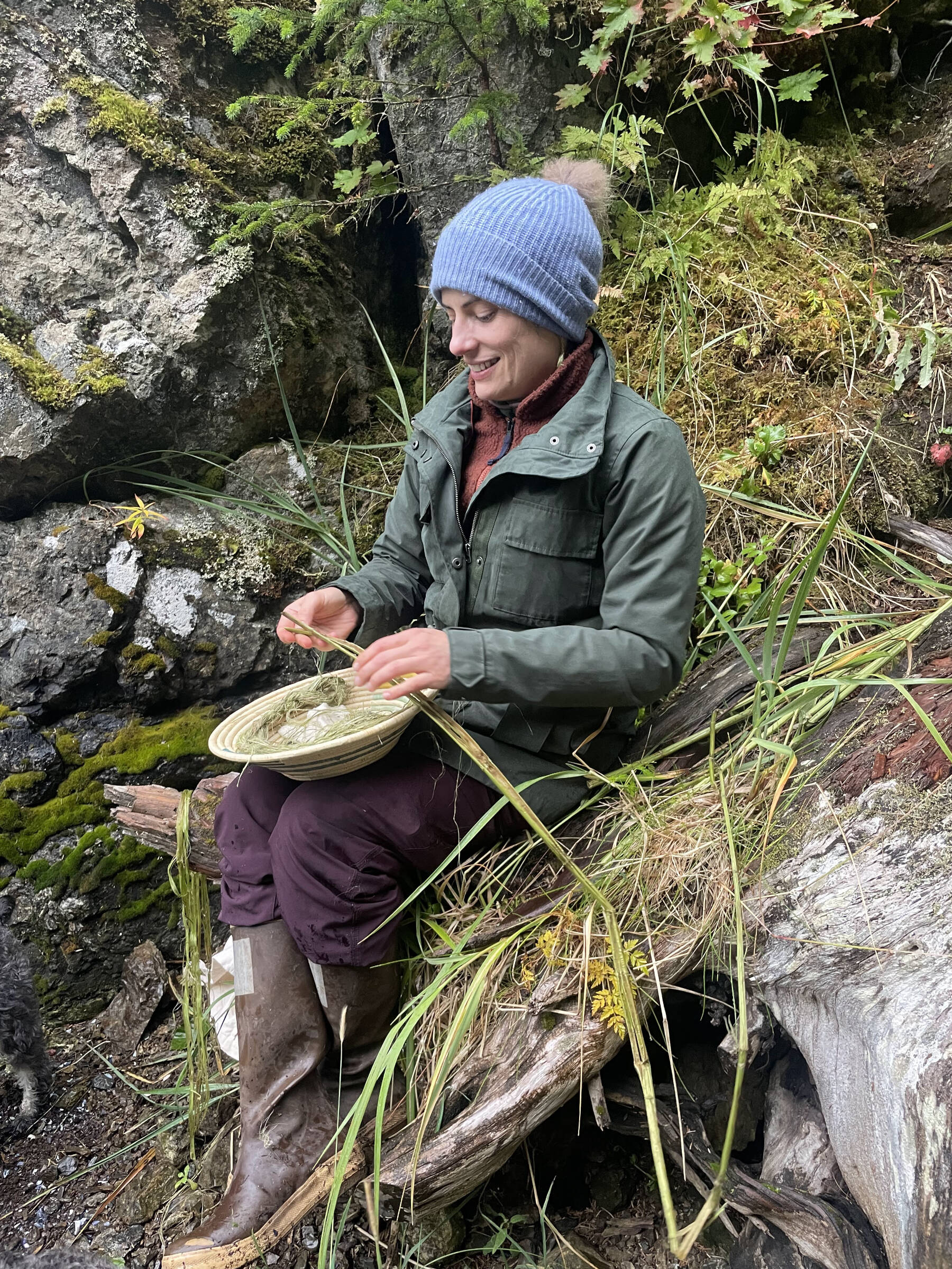 Artist Carla Klinker strips fresh nettles for processing into fiber to be used in future fiber arts projects in September 2025. Photo provided by Carla Klinker