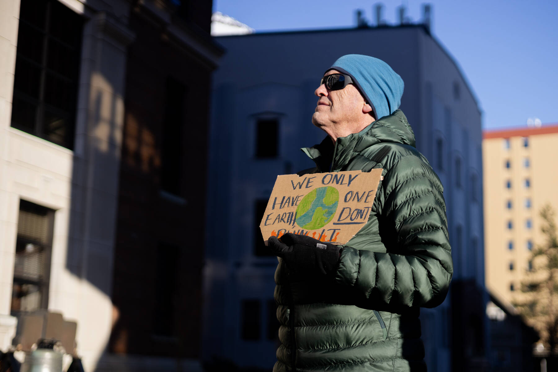 Photos by Chloe Anderson / Juneau Empire
Jeff Wilson holds a sign reading We only have one Earth, dont burn it during a protest led by the Juneau-Douglas High School: Yadaa.at Kalé chapter of Alaska Youth for Environmental Action outside the Alaska State Capitol on Saturday, Jan. 24<ins>, 2026</ins>.