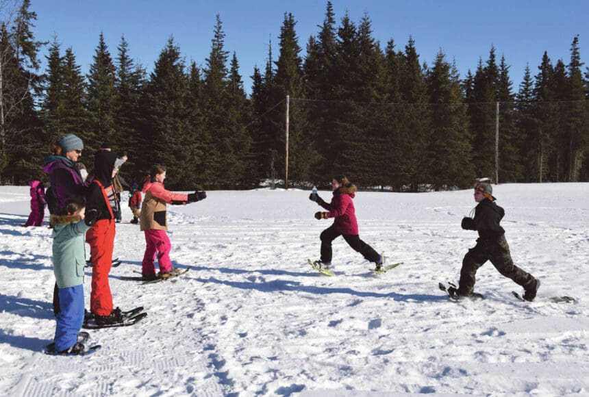 <p>Anchor Point youth run a relay during the Snow Rondi kids&rsquo; snowshoe races on Saturday, March 2, 2024 at Fireweed Meadows golf course in Anchor Point, Alaska. (Delcenia Cosman/Homer News)</p>