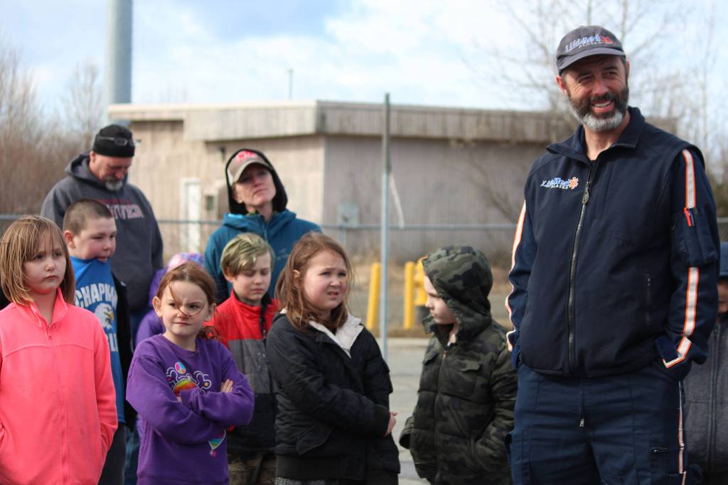 From left to right, Willow Hinsberger, William Greenstreet, Nevaeh Rawls and Josie Dubelisten to a presentation about LifeMed helicopters on Friday, May 11, 2018 behind the Chapman School in Anchor Point, Alaska.