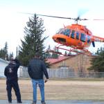 <span class="neFMT neFMT_PhotoCredit">Photo by Megan Pacer/Homer News</span>                                A LifeMed helicopter based out of Soldotna lands in front of Anchor Point Emergency Services Chief Al Terry (left) and Chapman School Principal Conrad Woodhead (right) on Friday, May 11 behind the school in Anchor Point. Woodhead and Terry contacted LifeMed to organize a demonstration for students.