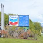 Workers with Prism Design and Construction, Wasilla, on Thursday, May 31, install Chevron signs at the Essential One gas station on the Sterling Highway and Poopdeck Street. (Photo by Michael Armstrong/Homer News)
