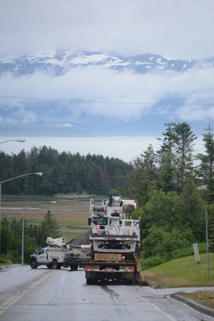 Homer Electric Association crews assess a downed line and pole on Heath Street about 3:15 p.m. Thursday, June 21. The truck in the foreground snagged a low-hanging telephone line, breaking a pole and bringing down a power line. The outage affected about 430 customers in downtown Homer. No one was injured in the incident. (Photo by Michael Armstrong / Homer News)