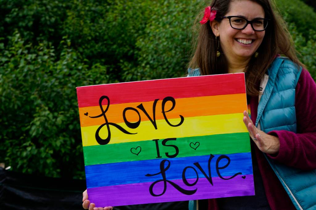 Kevyn Jalone shows a sign she carried in the Pride March on Saturday, June 23, 2018 in Homer, Alaska. (Photo by Michael Armstrong/Homer News)