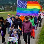 Participants in the Pride March walk over Beluga Slough on Saturday, June 23, 2018 in Homer, Alaska. (Photo by Michael Armstrong/Homer News)