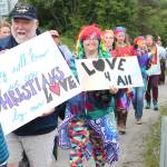 Participants in the Saturday, June 23, 2018 Pride March walk along Ocean Drive in Homer, Alaska with signs that read: They will know we are Christians by our love, and Love 4 all. About 280 people turned out for the inaugural march. (Photo by Megan Pacer/Homer News)