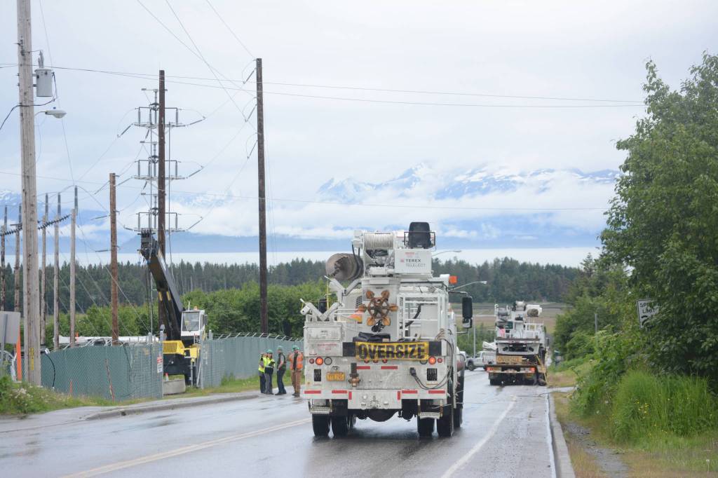 Homer Electric Association crews assess a downed line and pole on Heath Street about 3:15 p.m. Thursday, June 21. The truck in the background snagged a low-hanging telephone line, breaking a pole and bringing down a power line. The outage affected about 430 customers in downtown Homer. No one was injured in the incident. (Photo by Michael Armstrong / Homer News)