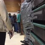 Fireweed Academy Principal Todd Hindman hangs suspended after being duct taped to the wall last Thursday in the mutlipurpose room. Students at West Homer and Fireweed Academy got the reward of plastering duct tape across the principals for filling up a jar with tokens handed out when a student showed good behavior like being respectful and responsible.