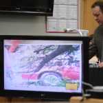 Kenai District Attorney Scot Leaders points to the image of a person in a red jacket during the trial of Demarqus Green on Friday. Green is charged with the murder of Demian Sagerser. The photo was taken by a game camera outside Sagerser's Stariski home.