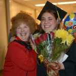 Cora Trowbridge, right, poses with Shawnie Olson, left, after she graduated with an associate of applied science degre in early childhood development University of Alaska Regent Lisa Parker confers the master of education hood for early childhood after Kachemak Bay Campus commencement last Wednesday.