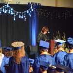 Homer High School graduates stand as counselor Lin Hampson reads their names and the scholarships they received. Graduates earned $890,305 in scholarships.