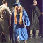 Victoria Chase leaves the stage after receiving her diploma at Homer High School Commencement on Tuesday night. Chase was one of several young women who wore XtraTuf boots at graduation.