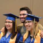 Patrick Lind poses with his sisters, Marissa, left, and Chelsea, right. The twins both graduated from Homer High School on Tuesday.